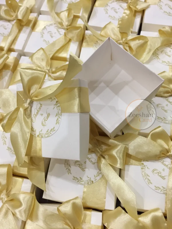 Golden Ribbon Box With Bow And Printed Tag